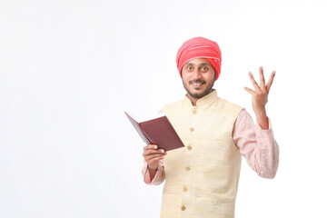 Indian farmer using diary on white background.