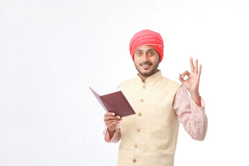 Indian farmer using diary on white background.