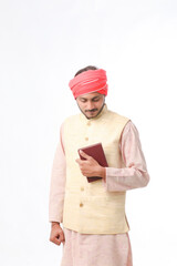 Indian farmer using diary on white background.