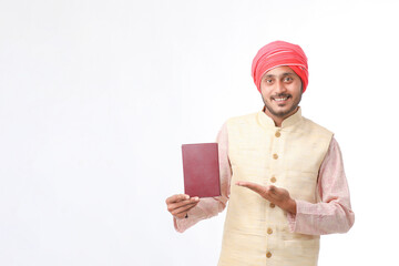 Indian farmer using diary on white background.