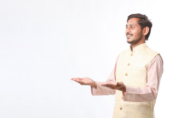 Young indian farmer in traditional wear and giving expression on white background.