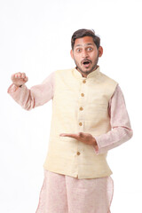 Young indian farmer in traditional wear and giving expression on white background.