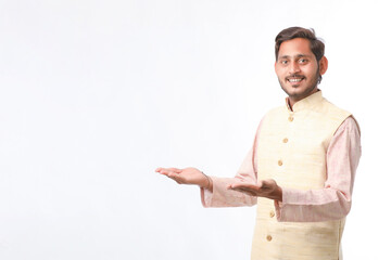Young indian farmer in traditional wear and giving expression on white background.