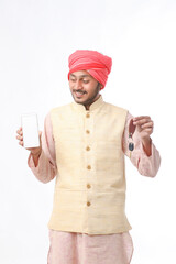 Young indian man showing smartphone and giving expression on white background.