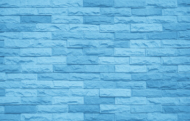 Brick wall painted with pale blue paint pastel calm tone texture background. Brickwork and stonework uneven design stack backdrop.