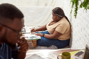 Young black modern couple working at home