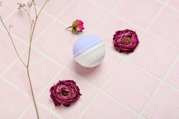 Composition with bath bomb and dried flowers on color tile