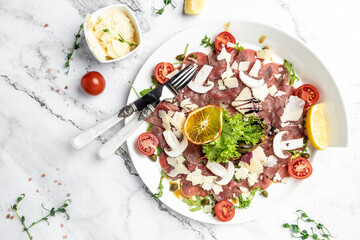 Beef Carpaccio with parmesan, capers and arugula. cold appetizer. banner, menu, recipe place for...