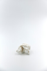 Zerknülltes Stück weißes Papier vor einem weißen Hintergrund