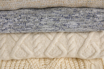 Fototapeta na wymiar Texture of stylish baby sweaters, closeup