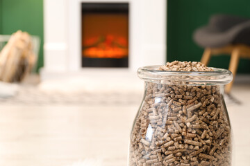 Jar with wood pellets in living room, closeup