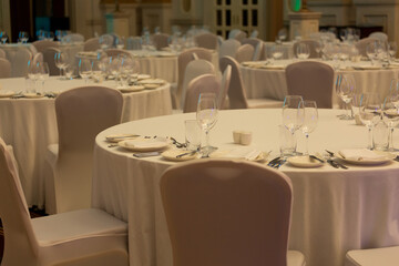 Banquet hall in the restaurant with table setting. Concept: Service. Celebration. Anniversary. Wedding