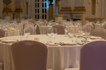 Banquet hall in the restaurant with table setting. Concept: Service. Celebration. Anniversary. Wedding