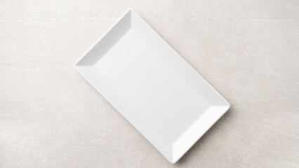 Rectangular white plate on a light stone background, the concept of food, restaurant