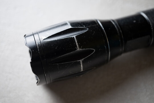 used flashlight shocker on a light background close-up, the concept of protection and security