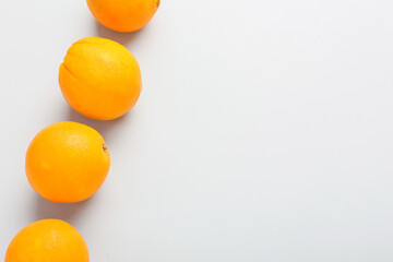 Ripe fresh oranges on white background