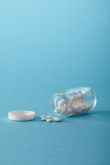 Clear Glossy Plastic Bottle with White Cap and white capsules