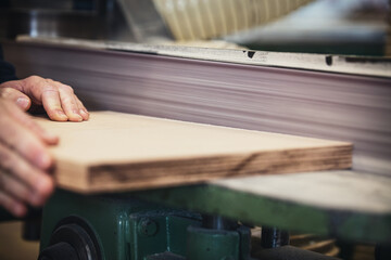 male craftman is working with a belt grinder