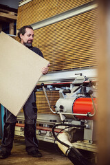 male craftman is working with a vertical panel saw