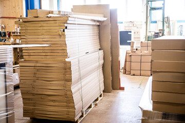 a large stack of goods packed in cartons in a warehouse or workshop