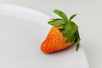 strawberry on a white plate