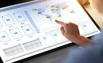 technology and people concept - hand on led light tablet or touch screen with files at night office