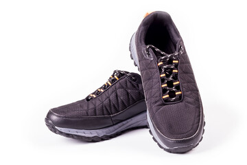 shooting in the studio. artificial light. sneakers are black on a white background. close-up