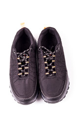 shooting in the studio. artificial light. sneakers are black on a white background. close-up