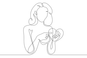 One continuous line.Beautiful woman holding a heart in her hands.Valentine's Day. Girl with a heart symbol of love. Continuous line drawing.Lineart isolated white background.