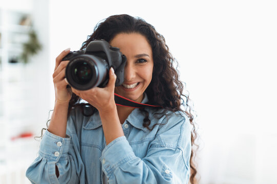 Happy Photographer Lady Taking Photo Holding Camera Near Face Indoors