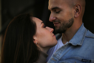 Close-up of a young couple looking at each other and smiling. Valentine's Day.