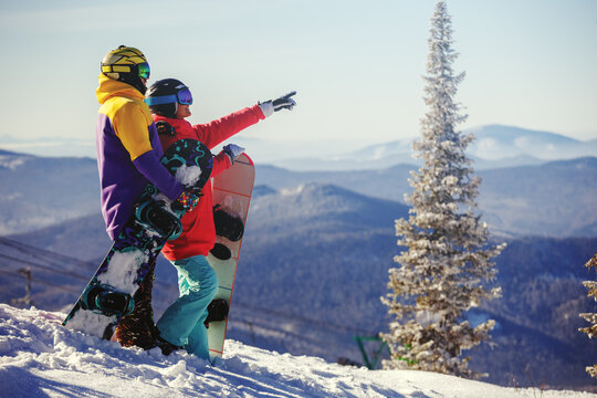 Young couple having fun with snowboards.