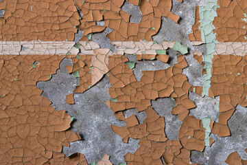 Peeling paint on the wall. Old concrete wall with cracked flaking paint. Weathered rough painted...