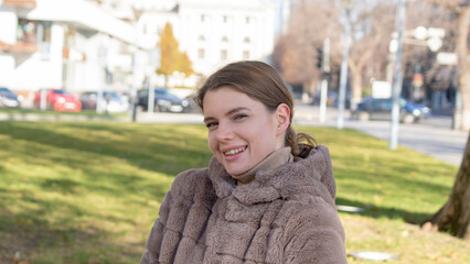 Outdoor lifestyle portrait of amazing glamorous luxury woman posing in city center. 