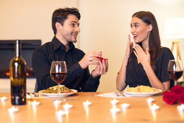 Young man making proposal with ring to his woman