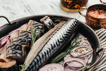 Fresh mackerel fish with salt, onion and spices on a metal tray. Seafood concept. banner, menu, recipe place for text, top view