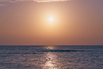 The sun rises over the Red Sea at dawn.