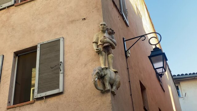 Peiresc hugging a small chimpanzee, allegory of Virgin and Child, on the facade of a building in Aix en Provence, France