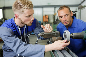 workers working with a metal grinder