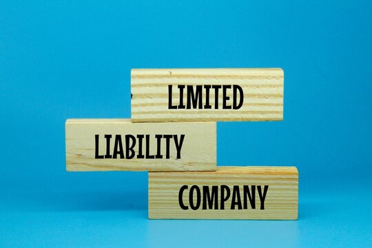 wooden boards are arranged randomly with the words limited liability company