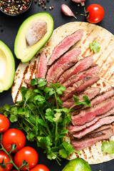 Tortilla with beef and vegetables. Ingredients for making tacos and burritos.