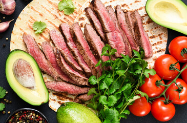 Tortilla with beef and vegetables. Ingredients for making tacos and burritos.