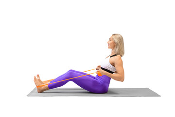 Resistance band seated back rows exercise. Attractive athletic woman sitting on a mat and work out...