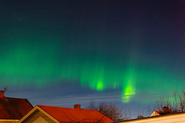 Northern lights (aurora borealis) visible as far south as Skara during a cold January night. Shimmering lights in green and some red higher up. Norrsken i Skara, Västra Götaland, Sverige