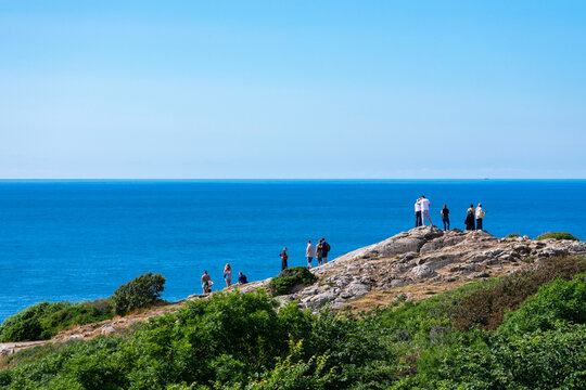 Cliff of Kullaberg mountain on the west coast of Sweden. Klippa p&aring; Kullaberg. Baltic sea in the distance behind the dramatic rocks. Sunshine on a warm summer day, Scandinavia. 