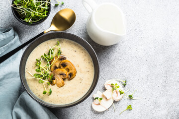 Mushroom Soup on light stone table. Champignon cream soup with herbs. Top view with copy space. - obrazy, fototapety, plakaty