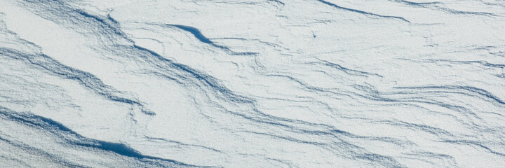 Snow texture with snow waves. Winter nature background.