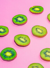 Fresh kiwi fruit on pink background, flat lay