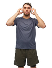 Fototapeta premium fitness, sport and healthy lifestyle concept - man in sports clothes with headphones listening to music over white background