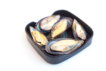 Fresh mussels were put on a black plate and served in Sukiyaki or Shabu buffet restaurant.